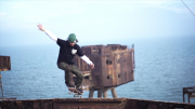 Skater performs tricks on abandoned WWII gun turret