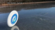 Frisbee just keeps on rolling on frozen lake